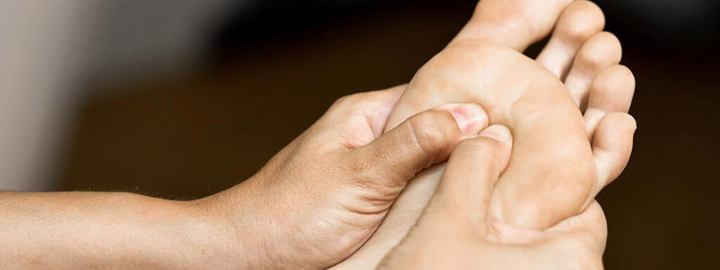 Medical massage at the foot in a physiotherapy center.